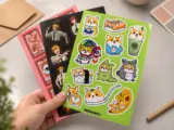 Vinyl sticker sheet with cute corgi illustration held in hand showcasing custom design - Sticker Sheet Printing
